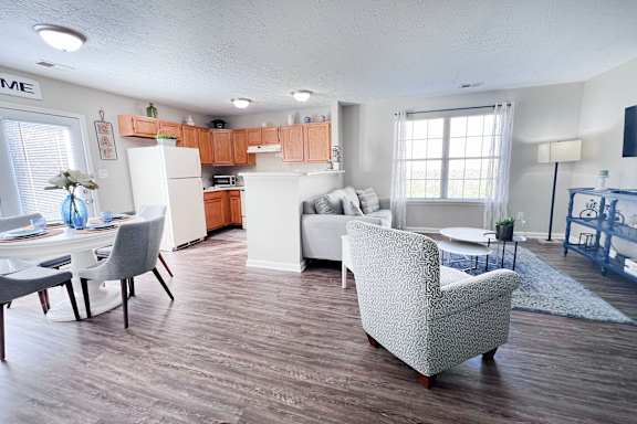 A kitchen with a dining table and chairs.