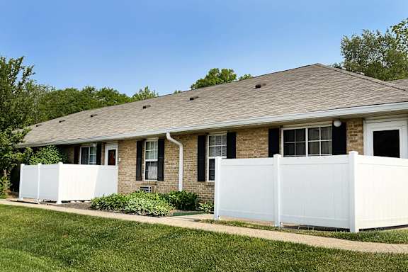 a house with a white fence in front of it