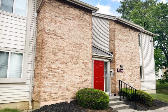 a red door on a brick building  at Hunter's Creek Apartments, Cincinnati