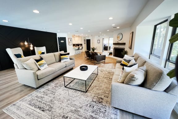a living room with couches and a coffee table in front of a fireplace at Indian Lookout Apartments, Cincinnati, OH