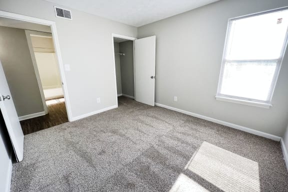 a bedroom with a carpeted floor and a large window at 450 on Keeneland, Richmond Kentucky