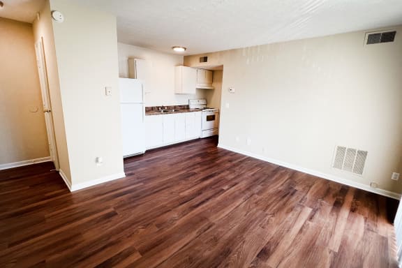 an empty living room and kitchen with wood flooring at Crown Crossing Apartments, Amelia, 45102