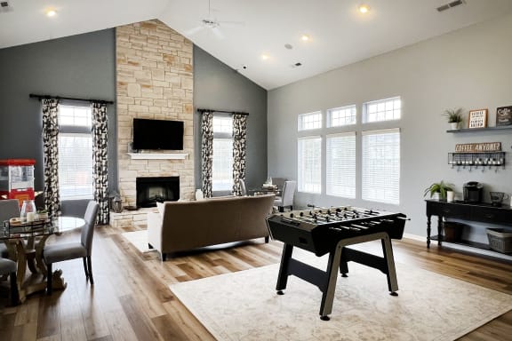 a game room with a foosball table and a couch  at Brookfield Village Apartments, Ohio, 43123