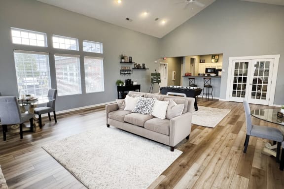 a living room with a couch and a table with chairs  at Brookfield Village Apartments, Ohio, 43123