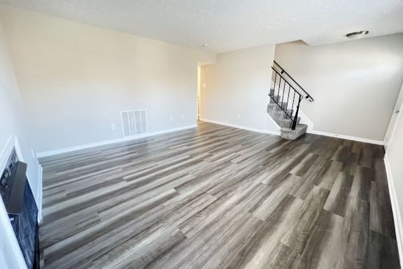 the living room and dining room of a home with wood flooringat Revere Village Apartments, Centerville, Ohio