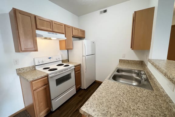 a kitchen with white appliances and granite counter tops  at Brookfield Village Apartments, Ohio, 43123