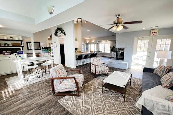 A living room with a dining table and chairs.