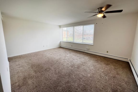 a bedroom with a ceiling fan and a window