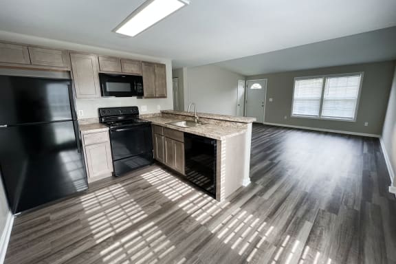 an open floor plan with a kitchen and living room