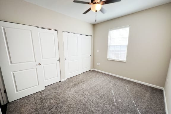 an empty bedroom with two closets and a ceiling fan at Parkway Trails, Florence, KY, 41042