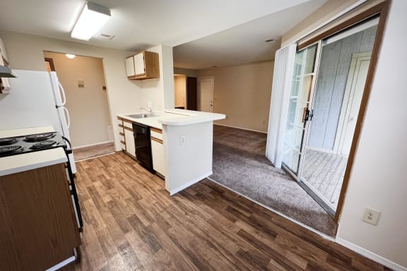 a kitchen and living room in a small apartment
