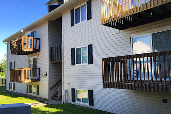 A two story house with a balcony on the second floor.