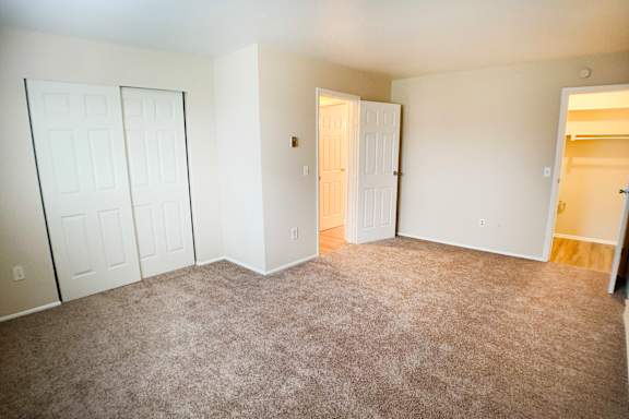 A room with a carpeted floor and white walls.