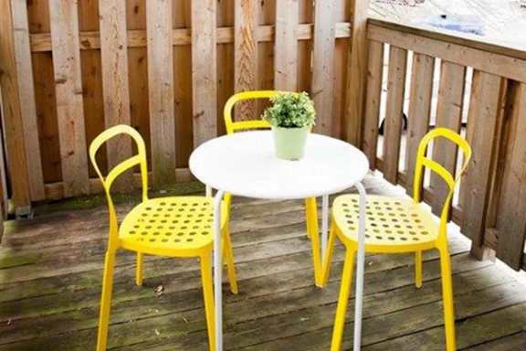 A small table with four chairs and a plant on it.