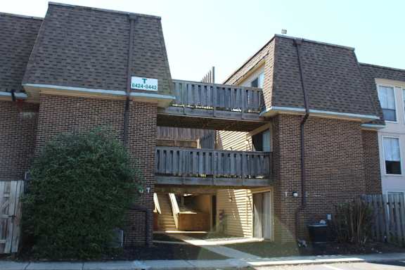 A house with a balcony and a door is shown.