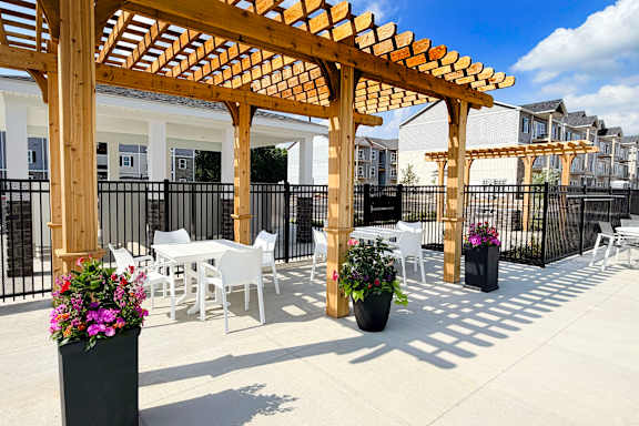 Outdoor dining patio with pergola and planters at The Meridian on 32 Apartments, Batavia, OH 45103