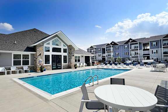 Swimming pool with lounge seating and clubhouse at The Meridian on 32 Apartments, Batavia, 45103