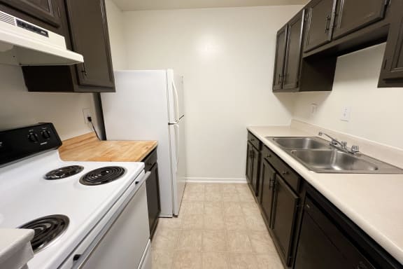 an empty kitchen with a stove sink and refrigeratorat Revere Village Apartments, Centerville, OH