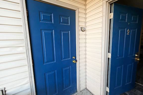 A blue door with a keyhole and a doorknob.
