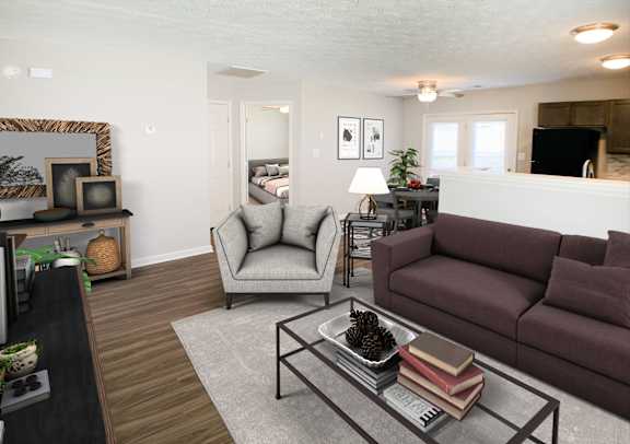 A living room with a grey couch and a brown couch.