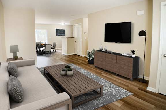 A living room with a grey couch and a wooden coffee table.