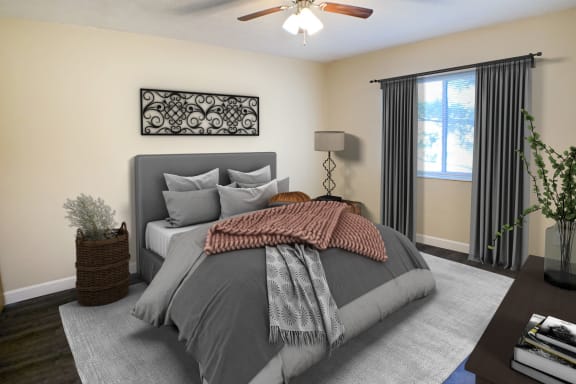 a bedroom with a bed and a ceiling fan at Quail Meadow Apartments, Ohio