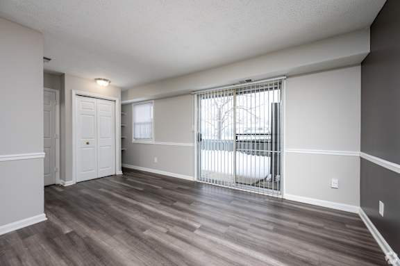 A room with a white door and a white chair.