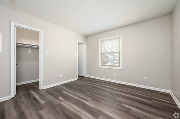 A room with a wooden floor and a window.