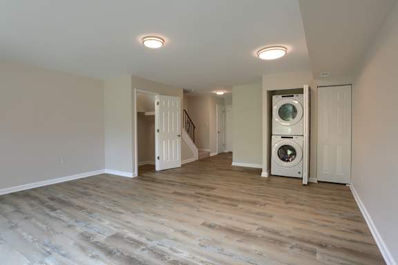A room with a washer and dryer built into the wall.