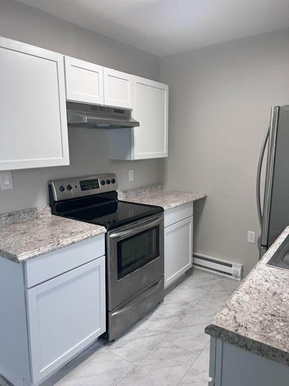 A kitchen with white cabinets and granite countertops.