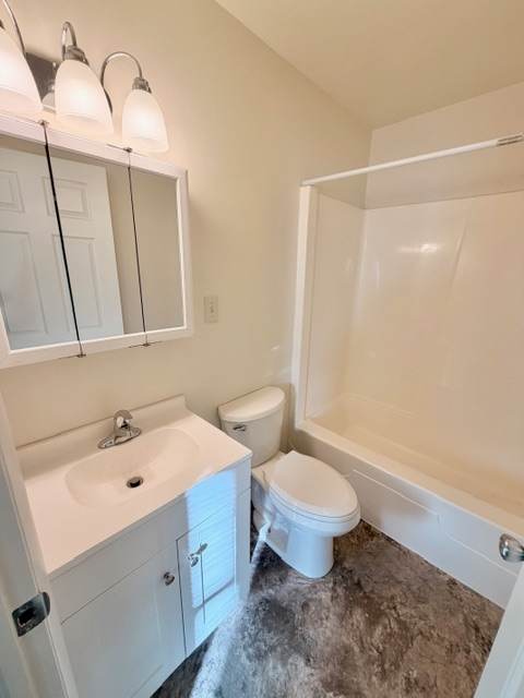 A white bathroom with a sink, toilet, and bathtub.