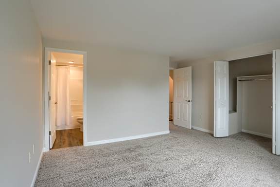 A room with carpeted floor and white walls.