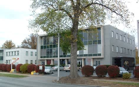 a large building with a tree in front of it