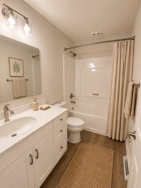 A bathroom with a white sink, toilet, and bathtub.