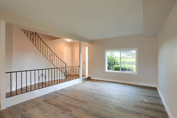 A room with a staircase and a window.