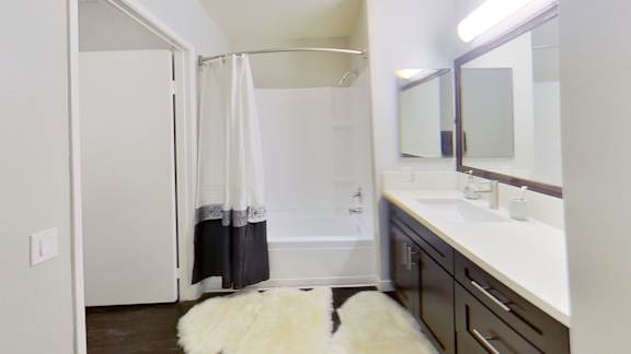 a bathroom with a shower and a sink and a mirror