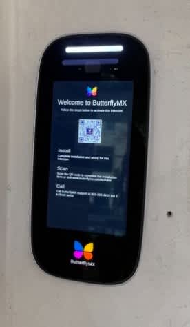 A ButterflyMX brand cell phone is displayed on a plain background.