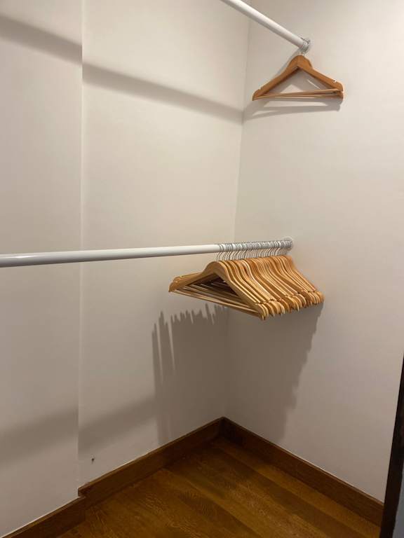 a walk in closet with a white wall and a rack with folded towels at 8535 Colgate-Fully Furnished Apartments, Los Angeles, California