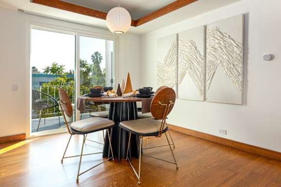 a dining room with a table and chairs and a window at 8535 Colgate-Fully Furnished Apartments, Los Angeles, 90048