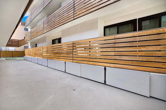 A long row of wooden slats are on the wall.