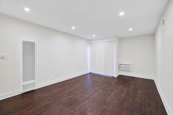 A room with wooden floors and white walls.