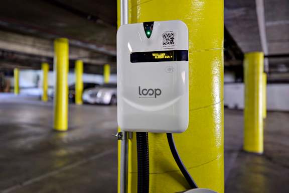 A white device labeled "loop" is attached to a yellow pole.