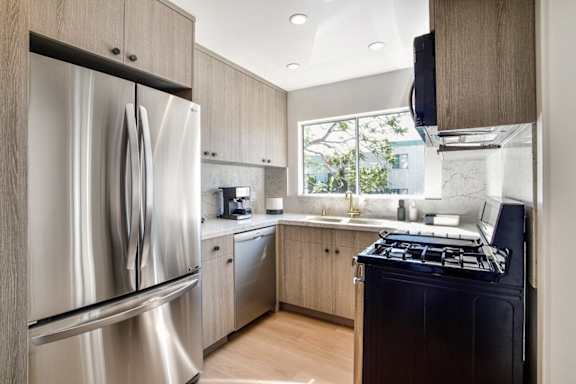 a kitchen with stainless steel appliances and a window