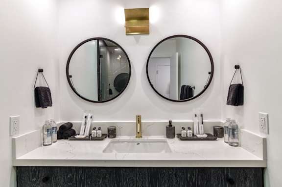 two mirrors above a bathroom sink in a hotel room at 8535 Colgate-Fully Furnished Apartments, California, 90048
