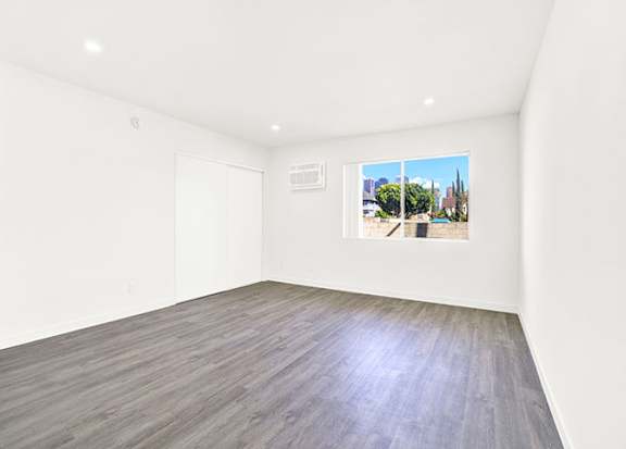 A room with a wooden floor and a picture on the wall at Bonnie Brae Apartments, California