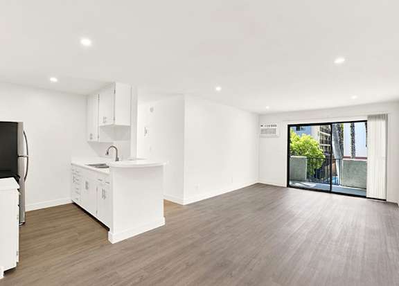 A kitchen with white cabinets and a wooden floor at Bonnie Brae Apartments, Apartments, Los Angeles, CA