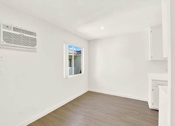 A room with a window and a wall-mounted air conditioner at Bonnie Brae Apartments, California, 90006