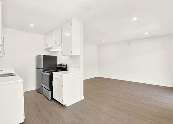 A kitchen with white appliances and cabinets at Bonnie Brae Apartments, California