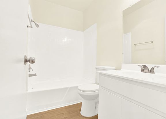 A white bathroom with a toilet, sink, and shower at Bonnie Brae Apartments, Los Angeles, 90006