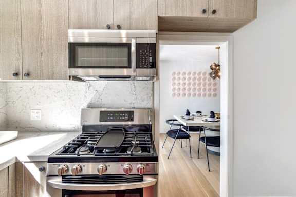a kitchen with a stove and a microwave     and a dining room at 8535 Colgate-Fully Furnished Apartments, Los Angeles, 90048
